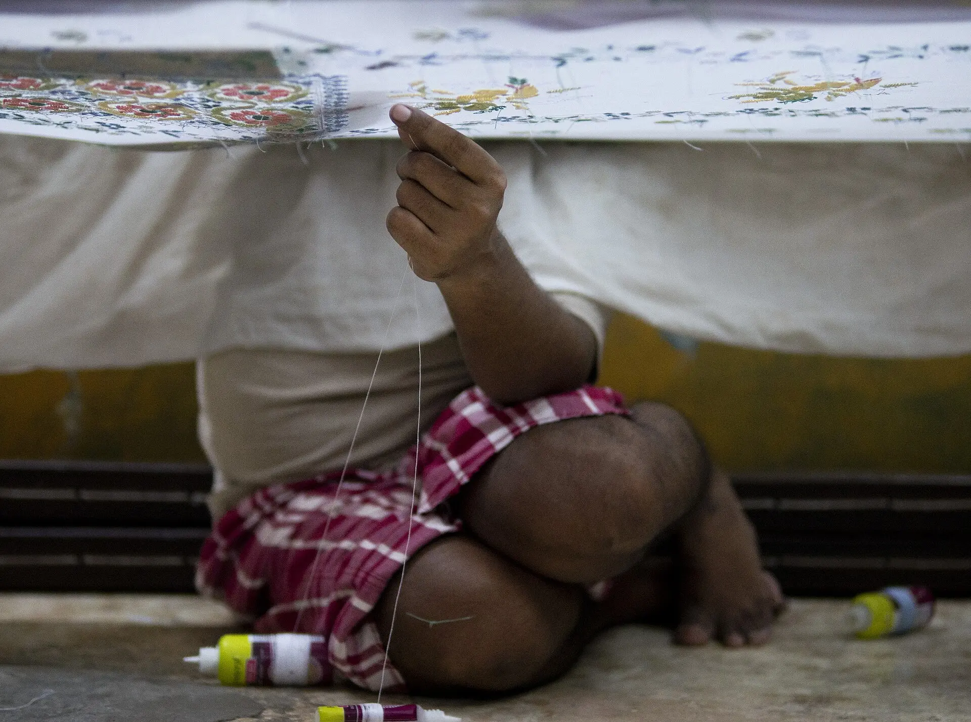 Aari artisan working on delicate floral embroidery